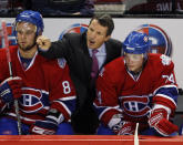 FILE - In this Oct. 4, 2008, file photo, Montreal Canadiens coach Guy Carbonneau, center, argues a call as Guillaume Latendresse, left, and Sergei Kostitsyn, right, look on during the first-period of an NHL preseason hockey game against the Minnesota Wild, in Montreal. Carbonneau was elected to the Hockey Hall of Fame, Tuesday, June 25, 2019. (AP Photo/The Canadian Press,Ryan Remiorz, File)