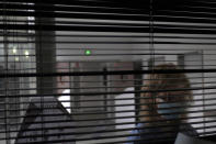 A patient looks through metal shutters in the Rouvray psychiatric hospital, in Rouen, western France, Wednesday, Nov. 25, 2020. Lockdowns that France has used to fight the coronavirus have come at considerable cost to mental health. Surveying points to a surge of depression most acute among people without work, in financial hardship and young adults. (AP Photo/Thibault Camus)