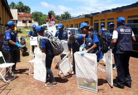 World Health Organization (WHO) workers prepare a centre for vaccination during the launch of a campaign aimed at beating an outbreak of Ebola in the port city of Mbandaka, Democratic Republic of Congo May 21, 2018. REUTERS/Kenny Katombe
