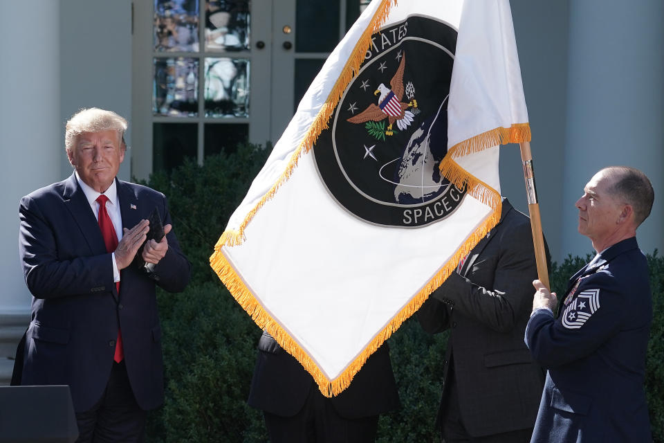 WASHINGTON, DC - AUGUST 29: U.S. President Donald Trump (L) applauds as the flag for the new the U.S. Space Command is revealed in the Rose Garden at the White House August 29, 2019 in Washington, DC. Citing potential threats from China and Russia and the nation’s reliance on satellites for defense operations, Trump said the U.S. needs to launch a 'space force.' U.S. Air Force Gen. John Raymond will serve as the first head of Space Command, which will have 87 active units handling operations such as missile warning, satellite surveillance, space control and space support. (Photo by Chip Somodevilla/Getty Images)