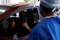 A plastic surgeon conducts drive-through Botox injections in the garage of his clinic in Miami