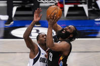 Brooklyn Nets guard James Harden (13) shoots against Dallas Mavericks forward Dorian Finney-Smith during during the second half of an NBA basketball game Saturday, Feb. 27, 2021, in New York. (AP Photo/John Minchillo)