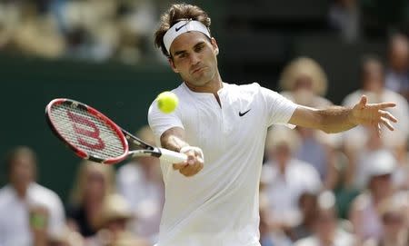 Roger Federer of Switzerland hits a shot during his match against Samuel Groth of Australia at the Wimbledon Tennis Championships in London, July 4, 2015. REUTERS/Henry Browne