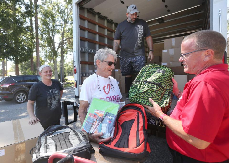 Marvin Miller, president of the Jewish Federation of Volusia & Flagler Counties, joins Robert Voges, principal of Holly Hill School, to check out a truckload of 150 backpacks delivered to the school on Tuesday as part of the Federation's annual Operation Backpack program. The school supply drive will provide some 9,000 backpacks to 89 schools in Volusia and Flagler counties.