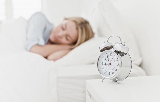 Resist the temptation to check clocks, phones and anything else that might wake you up. Photo: Getty images