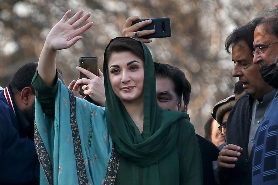 FILE - Maryam Nawaz Sharif, center, daughter of former Prime Minister Nawaz Sharif and a leader of the Pakistan Democratic Movement, an alliance of opposition parties, waves to supporters during a rally outside the head office of the Election Commission of Pakistan, in Islamabad, Pakistan, Tuesday, Jan. 19, 2021. A court in Pakistan's capital city on Thursday, Sept. 29, 2022, acquitted the daughter of former Prime Minister Nawaz Sharif, four years after she was sentenced to seven years in prison over purchases of luxury apartments in London. (AP Photo/Anjum Naveed, File)