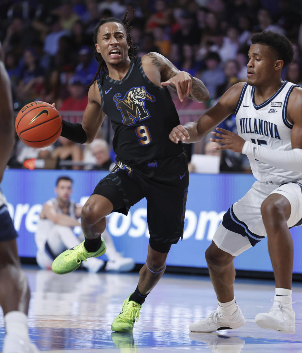 In a photo provided by Bahamas Visual Services, Memphis' Caleb Mills (9) looks to pass the ball during an NCAA college basketball game against Villanova in the Battle 4 Atlantis at Paradise Island, Bahamas, Friday, Nov. 24, 2023. (Tim Aylen/Bahamas Visual Services via AP)
