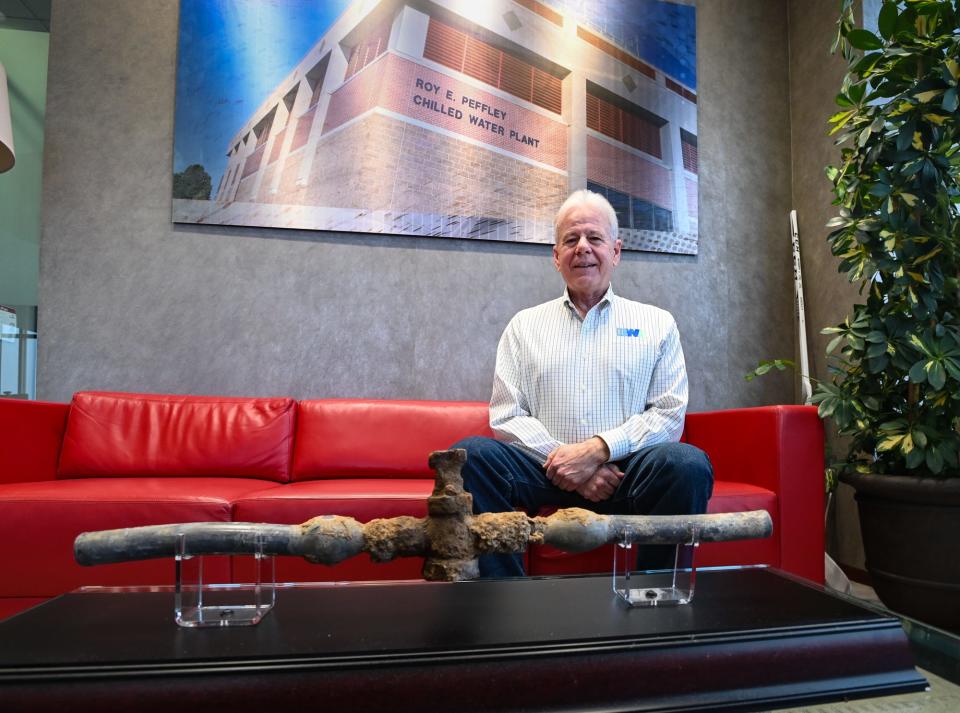 "We learned a lot throughout the process," BWL General Manager Dick Peffley says Thursday, Dec. 28, 2023, as he poses for a portrait with an ornamental display showcasing the last lead service line pulled from a BWL water customer's home in 2016.