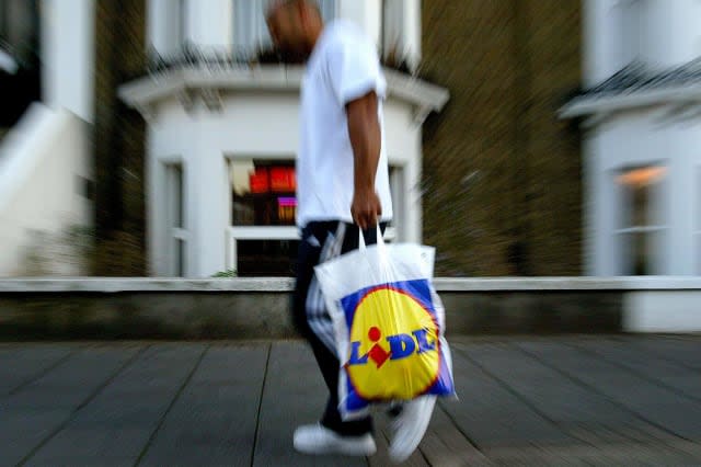 Generic, stock picture of a member of the public carrying a Lidl Supermarket shopping bag in London....