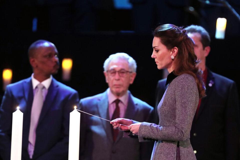Kate Middleton lights a candle during the UK Holocaust Memorial Day Commemorative Ceremony | Chris Jackson/Getty
