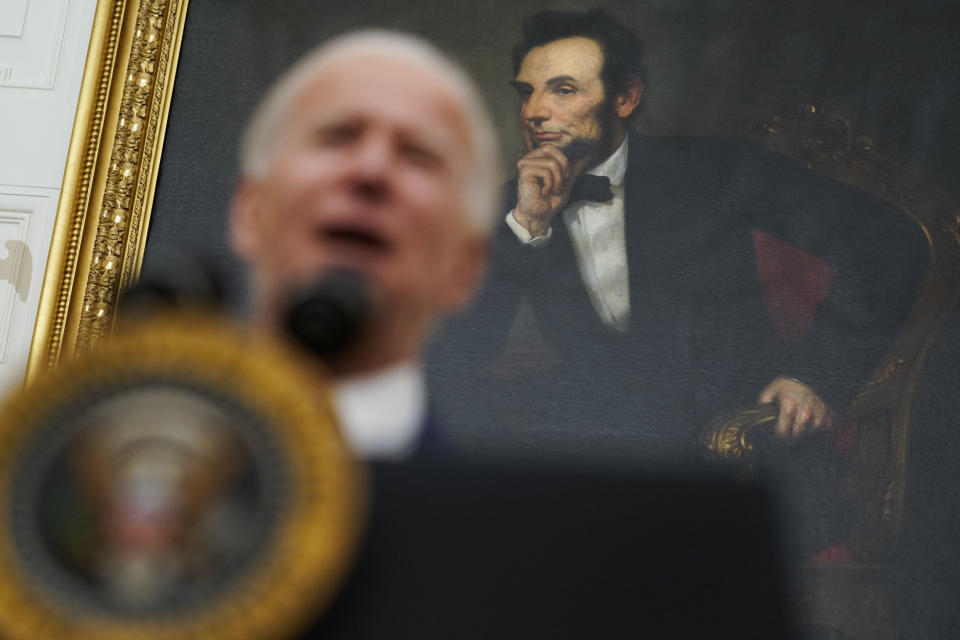 A portrait of former President Abraham Lincoln President hangs in the State Dining Room of the White House as Joe Biden delivers remarks on the economy Friday, Jan. 22, 2021, in Washington. (AP Photo/Evan Vucci)