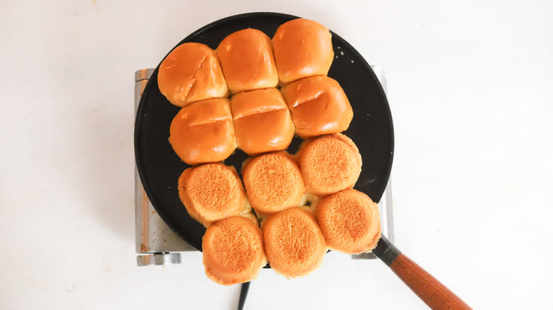 buns toasting on a skillet