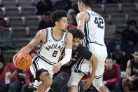 Vanderbilt's Scotty Pippen Jr. (2) controls the ball as Quentin Millora-Brown (42) blocks the path of Temple's Tai Strickland in the first half of an NCAA college basketball game Tuesday, Dec. 7, 2021, in Nashville, Tenn. (AP Photo/Mark Humphrey)