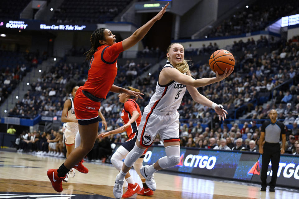 UConn guard Paige Bueckers shoots as Dayton guard Anyssa Jones defends in the first half of an NCAA college basketball game, Wednesday, Nov. 8, 2023, in Storrs, Conn. (AP Photo/Jessica Hill)