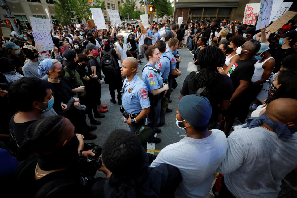 Protesters completely surround a line of police officers during nationwide unrest following the death in Minneapolis police custody of George Floyd, in Raleigh, North Carolina, U.S. May 30, 2020. Picture taken May 30, 2020. REUTERS/Jonathan Drake