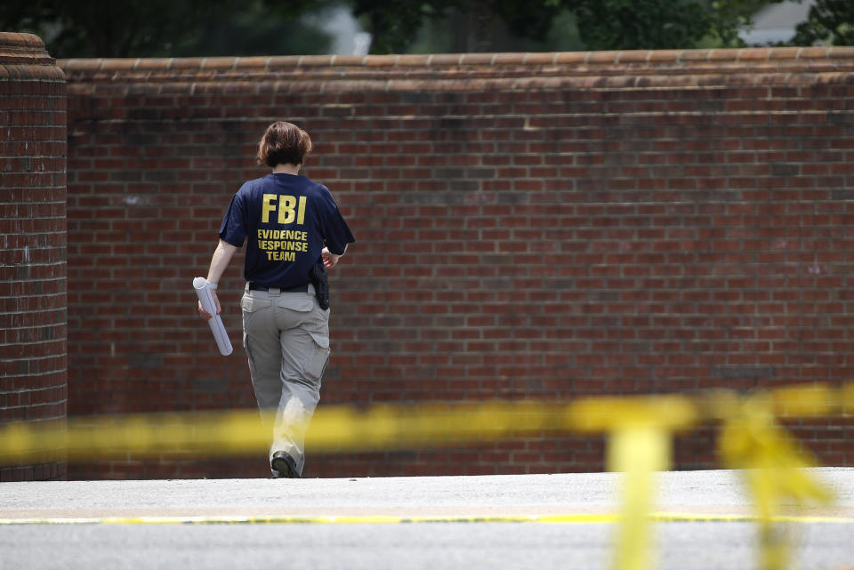 A member of the FBI walks down a ramp to enter a municipal building that was the scene of a shooting, Sunday, June 2, 2019, in Virginia Beach, Va. (Photo: Patrick Semansky/AP)