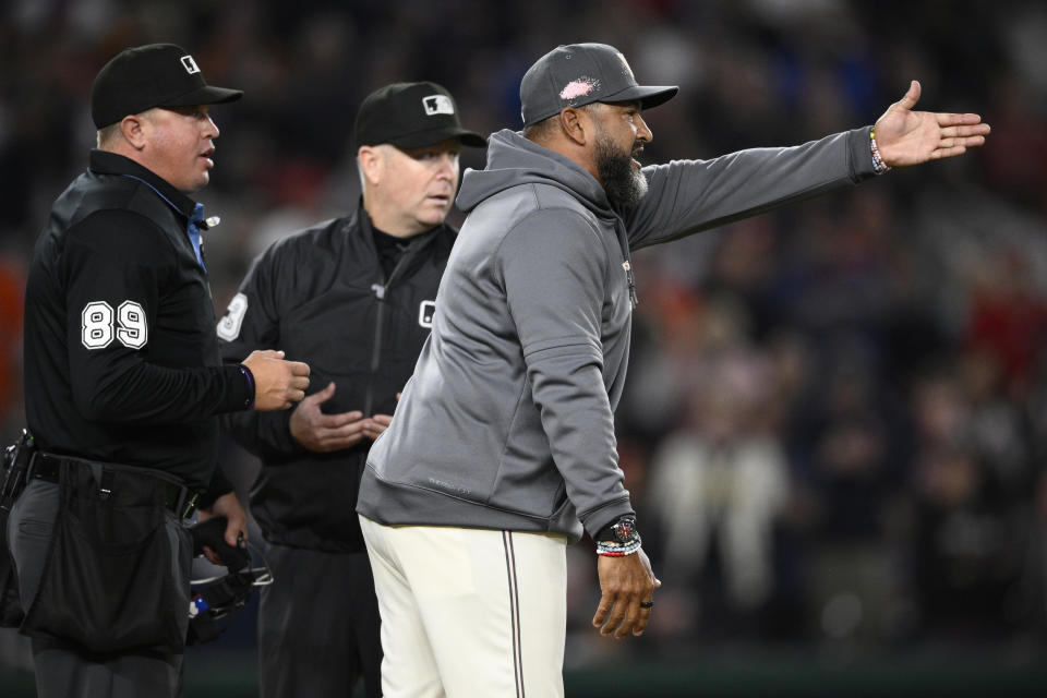 Washington Nationals manager Dave Martinez, right, argues with home plate umpire Cory Blaser, left, and third base umpire umpire Todd Tichenor, center, after he was ejected at the end of the eighth inning of a baseball game against the Houston Astros, Friday, April 19, 2024, in Washington. Martinez was arguing after a play at second which was upheld on review. (AP Photo/Nick Wass)