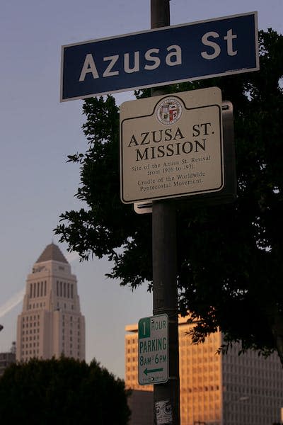 City Hall can be seen in the background of a memorial to the Azusa Street Mission in Los Angeles. <a href="https://www.gettyimages.com/detail/news-photo/city-hall-can-be-seen-in-the-backround-at-the-proposed-site-news-photo/564045807?phrase=azusa%20street&adppopup=true" rel="nofollow noopener" target="_blank" data-ylk="slk:Richard Hartog/Los Angeles Times via Getty Images;elm:context_link;itc:0;sec:content-canvas" class="link ">Richard Hartog/Los Angeles Times via Getty Images</a>