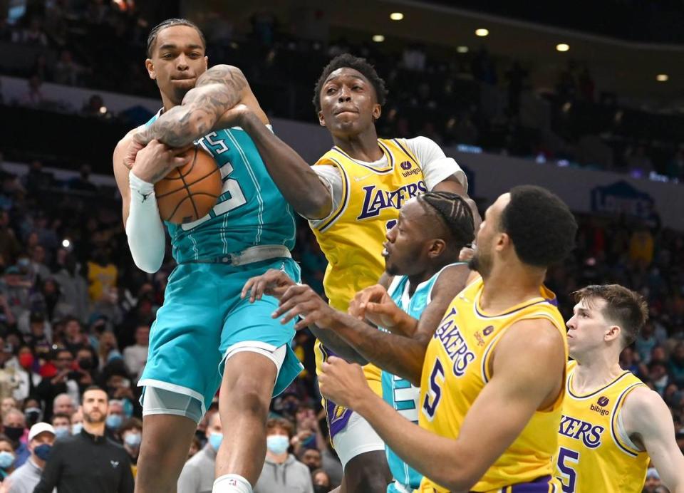 Charlotte Hornets forward PJ Washington, left, grabs the final rebound against the Los Angeles Lakers at Spectrum Center in Charlotte, NC on Friday, January 28, 2022. The Hornets defeated the Lakers, 117-114. Washington rebounded a missed Russell Westbrook three-pointer that would have given the Lakers the lead.