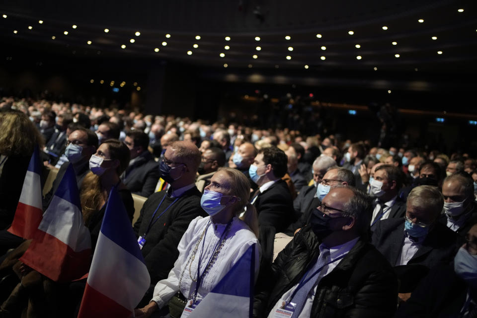 Fans listen to Valerie Pecresse, candidate for the French presidential election 2022, as she delivers a speech during a meeting in Paris, France, Saturday, Dec. 11, 2021. The first round of the 2022 French presidential election will be held on April 10, 2022 and the second round on April 24, 2022. (AP Photo/Christophe Ena)