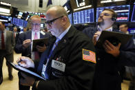 Trader Jeffrey Vazquez works on the floor of the New York Stock Exchange, Friday, Nov. 15, 2019. Stocks are opening broadly higher on Wall Street as hopes continued to grow that the U.S. and China were moving closer to a deal on trade. (AP Photo/Richard Drew)