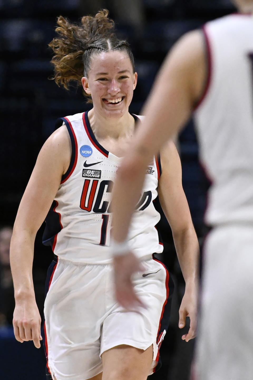 UConn guard Ashlynn Shade reacts toward teammate Nika Muhl, right, in the first half of a first-round college basketball game against Jackson State in the NCAA Tournament, Saturday, March 23, 2024, in Storrs, Conn. (AP Photo/Jessica Hill)