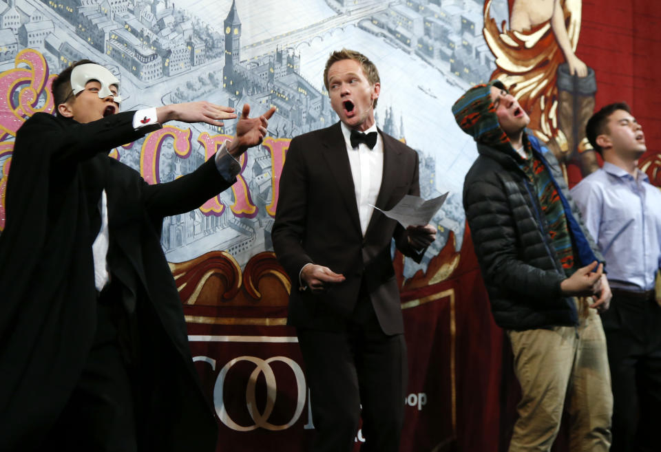 Actor Neil Patrick Harris, center, performs onstage with student actors during his roast as Man of The Year by Harvard University's Hasty Pudding Theatricals in Cambridge, Mass., Friday, Feb. 7, 2014. (AP Photo/Elise Amendola)