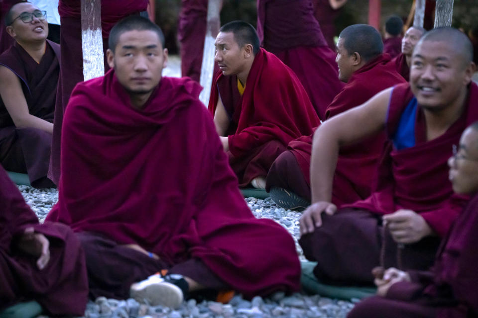 Monks in crimson robes hold debate sessions in an outdoor area at the Tibetan Buddhist College near Lhasa in western China's Tibet Autonomous Region, as seen during a rare government-led tour of the region for foreign journalists, Monday, May 31, 2021. Long defined by its Buddhist culture, Tibet is facing a push for assimilation and political orthodoxy under China's ruling Communist Party. (AP Photo/Mark Schiefelbein)