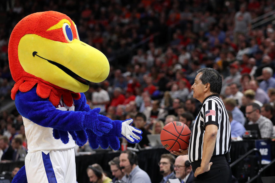 <p>The Kansas Jayhawks mascot interacts with a referee during the first half of the game between the Northeastern Huskies and the Kansas Jayhawks in the first round of the 2019 NCAA Men’s Basketball Tournament at Vivint Smart Home Arena on March 21, 2019 in Salt Lake City, Utah. (Photo by Patrick Smith/Getty Images) </p>