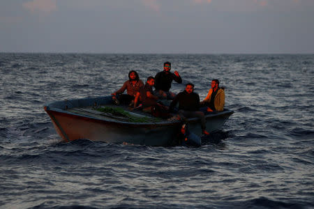 (L-R) Libyan migrants Alaa, Rami, Hamza, Mohammed, and Rafat on a wooden boat await rescue by the migrant search and rescue vessel MV Seefuchs of the German NGO Sea-Eye in the search and rescue zone some fifty nautical miles north of the Tunisian-Libyan land border, September 30, 2017. REUTERS/Darrin Zammit Lupi