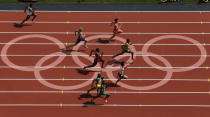 Jamaica's Yohan Blake (R) takes the lead in his men's 100m round 1 heats at the London 2012 Olympic Games at the Olympic Stadium August 4, 2012. REUTERS/Pawel Kopczynski (BRITAIN - Tags: OLYMPICS SPORT ATHLETICS) 