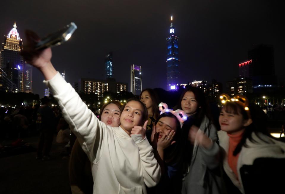 People wear New Year’s costumes and take photo to wait the turn of the year in Taipei, Taiwan (AP)