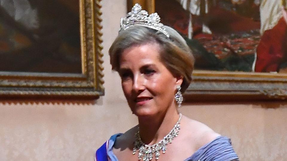 Duchess Sophie in a blue dress with a sash and a diamond tiara