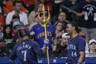Seattle Mariners' Jorge Polanco (7) is presented with a trident by Julio Rodríguez (44) after hitting a solo home run during the third inning of a baseball game against the Houston Astros Friday, May 3, 2024, in Houston. (AP Photo/Kevin M. Cox)