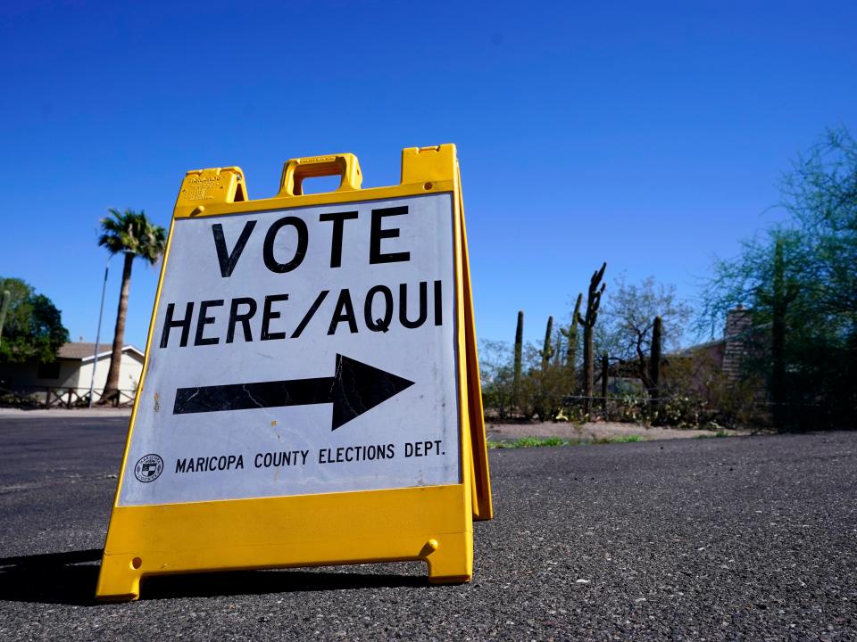 A sign marks the entrance to a voting precinct on the first day of early voting in the general election in Phoenix, Oct. 12, 2022.
