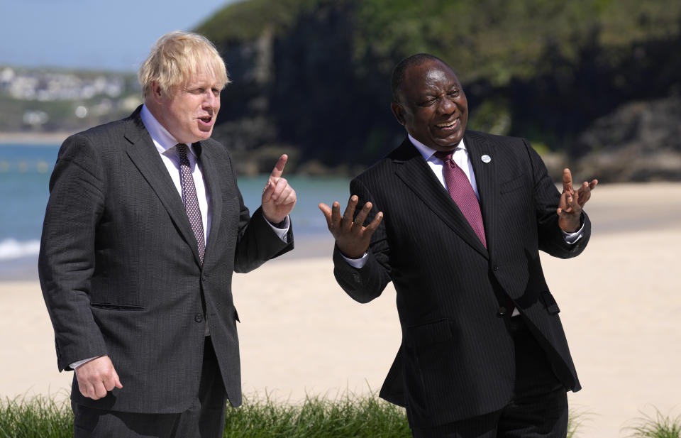 British Prime Minister Boris Johnson, left greets South African President Cyril Ramaphosa during arrivals for the G7 meeting at the Carbis Bay Hotel in Carbis Bay, St. Ives, Cornwall, England, Saturday, June 12, 2021. Leaders of the G7 gather for a second day of meetings on Saturday, in which they will discuss COVID-19, climate, foreign policy and the economy. (AP Photo/Kirsty Wigglesworth, Pool)