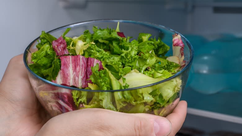 Removing salad bowl from fridge