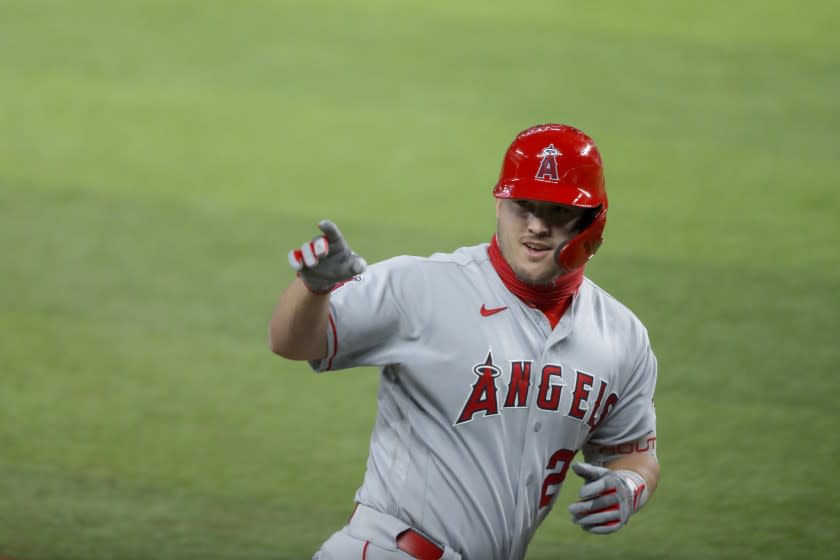 Los Angeles Angels' Mike Trout waves to the dugout after hitting a two-run home run.