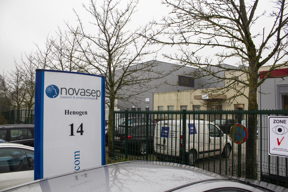 Cars are parked at the entrance of Novasep factory in Seneffe, Belgium, Thursday, Jan. 28, 2021. Belgian health authorities said Thursday they have inspected a pharmaceutical factory located in Belgium to find out whether the expected delays in the deliveries of AstraZeneca's coronavirus vaccines are due to production issues. The Novasep factory in the town of Seneffe is part of the European production chain for AstraZeneca's coronavirus vaccine. (AP Photo/Mark Carlson)