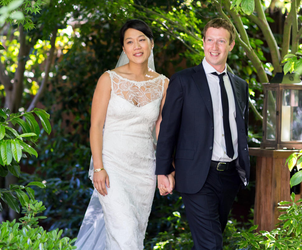 This photo provided by Facebook shows Facebook founder and CEO Mark Zuckerberg and Priscilla Chan at their wedding ceremony in Palo Alto, Calif., Saturday, May 19, 2012. Zuckerberg updated his status to "married" on Saturday. The ceremony took place in Zuckerberg's backyard before fewer than 100 guests, who all thought they were there to celebrate Chan's graduation. (AP Photo/Facebook, Allyson Magda Photography)