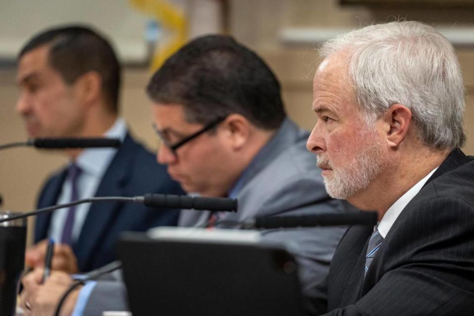 City Commissioner Kirk R. Menendez, right, listens to speakers during the public comment section of the Sept. 13, 2023 City of Coral Gables Commission meeting. Commissioner Ariel Fernandez, center and Mayor Vince Lago are also in the photo.