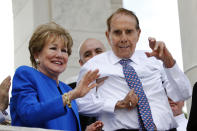 FILE - Former Sen. Bob Dole, right, and his wife Elizabeth Dole acknowledge well-wishers during a Memorial Day ceremony, Monday, May 27, 2019, at Arlington National Cemetery in Arlington, Va. Bob Dole, who overcame disabling war wounds to become a sharp-tongued Senate leader from Kansas, a Republican presidential candidate and then a symbol and celebrant of his dwindling generation of World War II veterans, has died. He was 98. His wife, Elizabeth Dole, posted the announcement Sunday, Dec. 5, 2021, on Twitter. (AP Photo/Patrick Semansky, File)