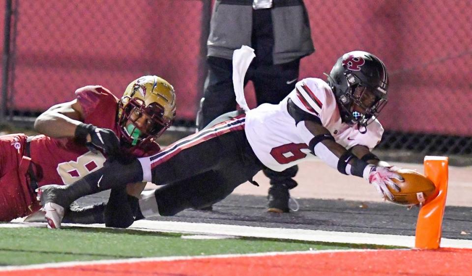 Warner Robins’ Jafredrick Perry (6) dives for the pylon for a touchdown during the Demons’ GHSA 5A semifinal game against Creekside Friday night in College Park.