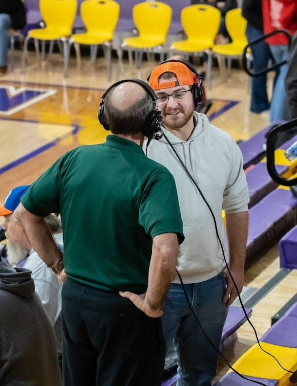 Zach Piatt (right) talks with Rick Fletcher (left) on a livestream during a basketball game.