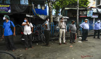 People wearing face masks to prevent the spread of the coronavirus stand maintaining social distance at a bust stop in Kolkata, India, Tuesday, Sept. 15, 2020. India's coronavirus cases are now the second-highest in the world and only behind the United States. (AP Photo/Bikas Das)