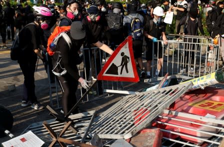 Anti-government protesters make a barricade during a march in Tuen Mun, Hong Kong