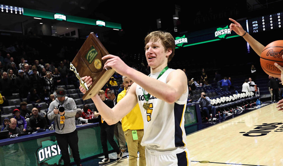 Moeller senior Noah George holds up the district championship trophy after their win over Springboro Sunday March 10, 2024.