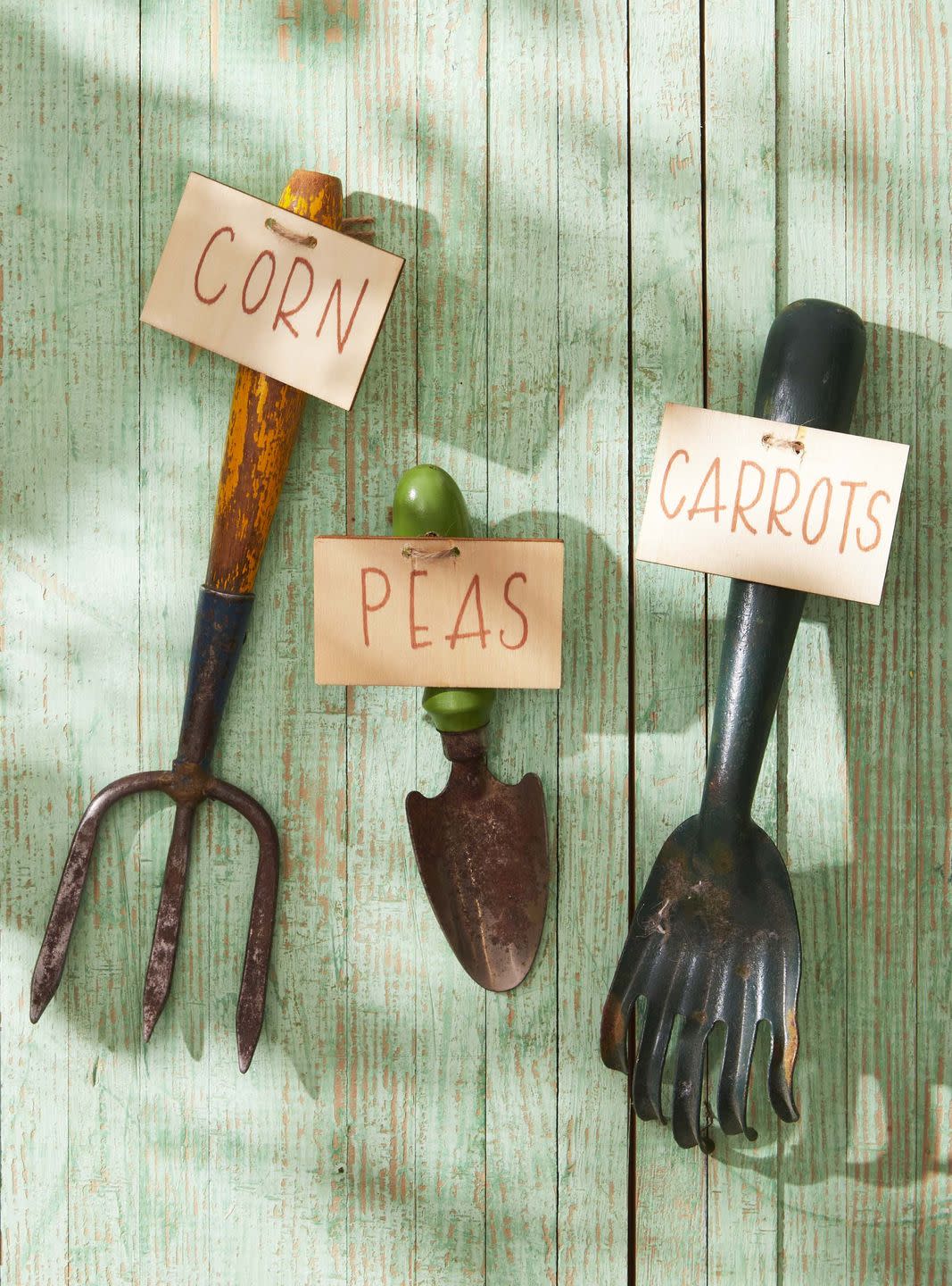 vintage garden stakes outfited with garden marker sign such as peas carrots etc