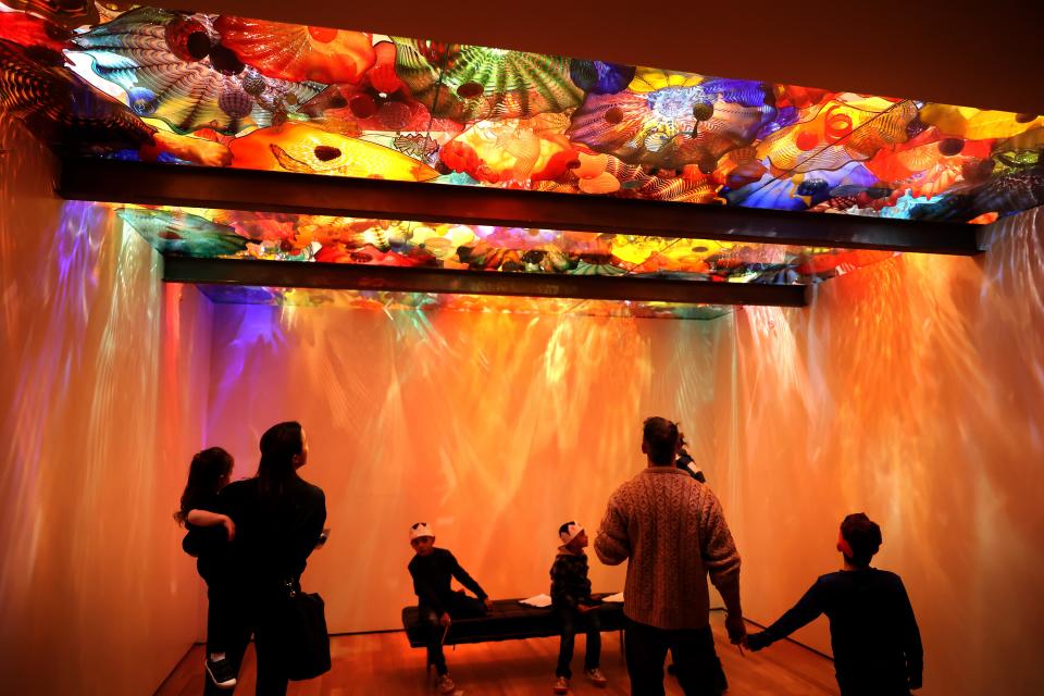 Families look for scavenger hunt items in Dale Chihuly's "Oklahoma Persian Ceiling" during the Noon Year's Eve Eve festivities at the Oklahoma City Museum of Art in Oklahoma City, Saturday, Dec. 30, 2023.