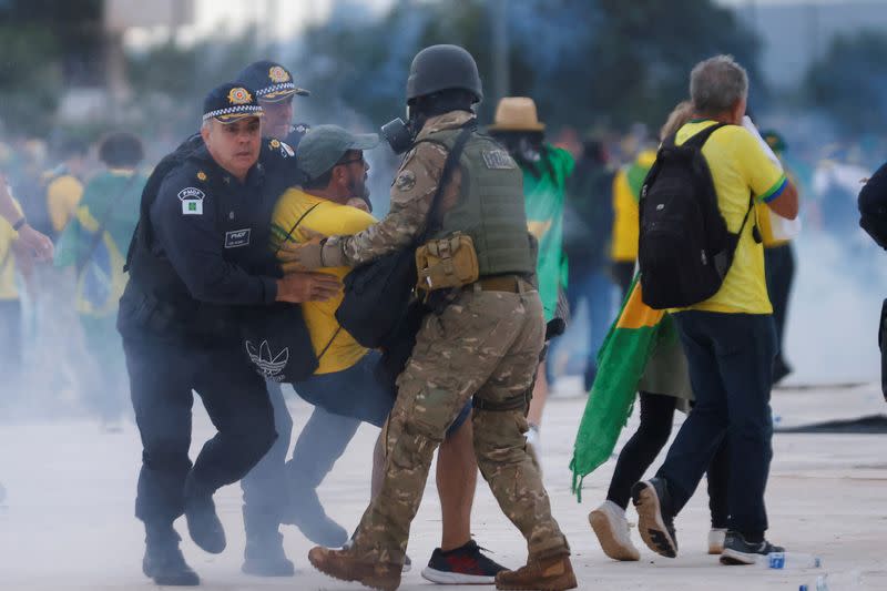 Colonel Naime detains a supporter of Bolsonaro during a demonstration against President Lula in Brasilia